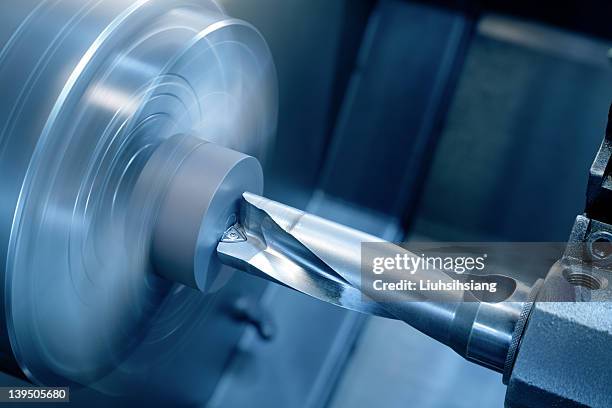 a silver drill in high speed motion - machining stock pictures, royalty-free photos & images