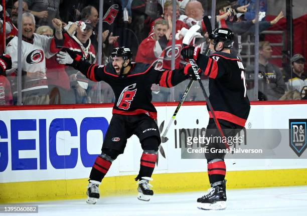 Vincent Trocheck celebrates after a goal by teammate Teuvo Teravainen of the Carolina Hurricanes against the Boston Bruins during the third period of...