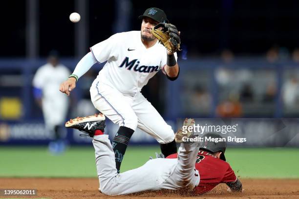 Jordan Luplow of the Arizona Diamondbacks steals second base past Miguel Rojas of the Miami Marlins during the eighth inning at loanDepot park on May...