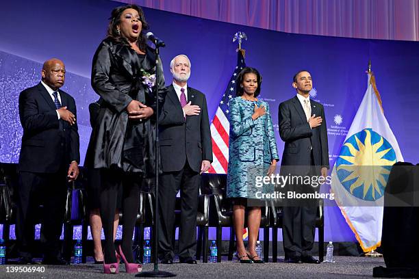 President Barack Obama, far right, and first lady Michelle Obama listen to the national anthem at the groundbreaking ceremony of the Smithsonian...