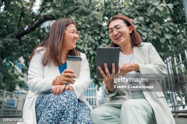 professional business transgender which disability on hand working business with digital tablet at outdoor in downtown district. - neurodiversidad fotografías e imágenes de stock