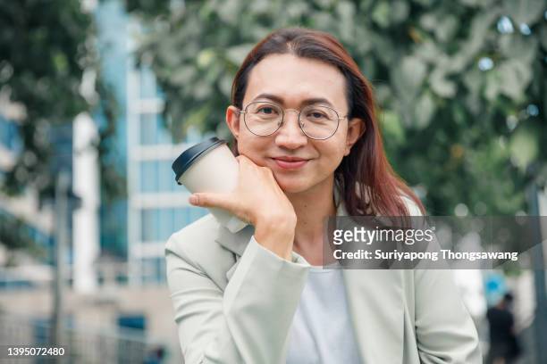 professional business transgender have coffee break relaxing at outdoor in downtown district. - disabled accessibility stock pictures, royalty-free photos & images