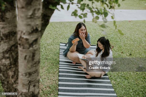 happy life on weekend, picnic in the garden on nice weather day. - asian eating hotdog stock pictures, royalty-free photos & images