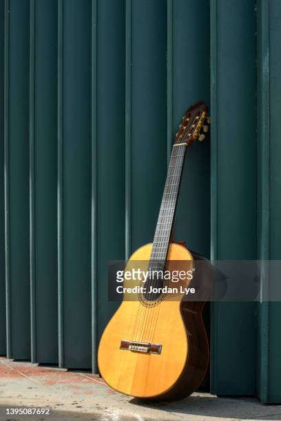 guitar leaning on a foldable steel door - pieghevole foto e immagini stock