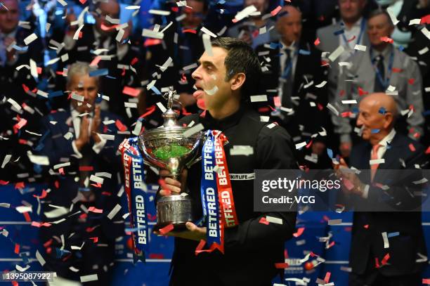 Ronnie O'Sullivan of England celebrates with the trophy after winning the final match against Judd Trump of England on day 17 of the Betfred World...