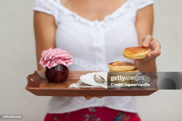 woman holding a stack of pancakes and jam on a tray - traditionally austrian stock pictures, royalty-free photos & images