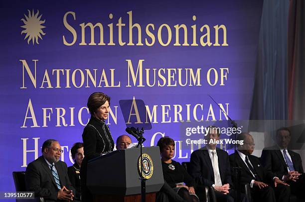 Former U.S. First lady Laura Bush speaks as museum director Lonnie Bunch, chair of Smithsonian Board of Regents France Cordova, co-chair of National...