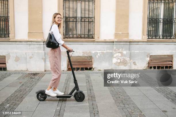 businesswoman on a electric scooter - scooter stock pictures, royalty-free photos & images