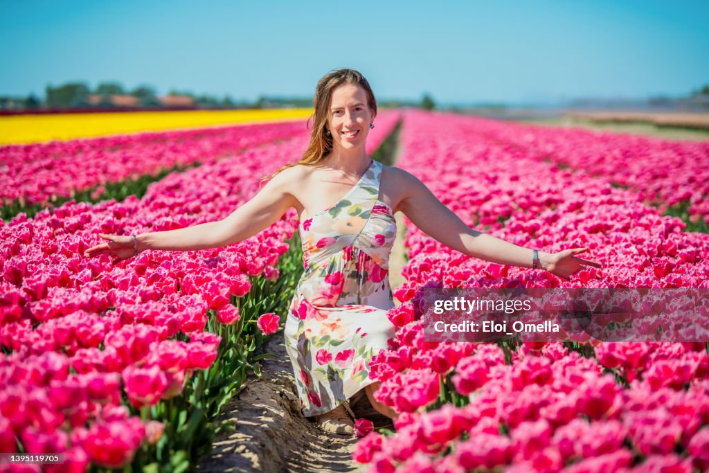 Dutch woman crouched at the tulip field in Netherlands