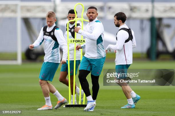 Oleksandr Zinchenko, Riyad Mahrez, Gabriel Jesus and Bernardo Silva of Manchester City participate in a training session at Manchester City Football...