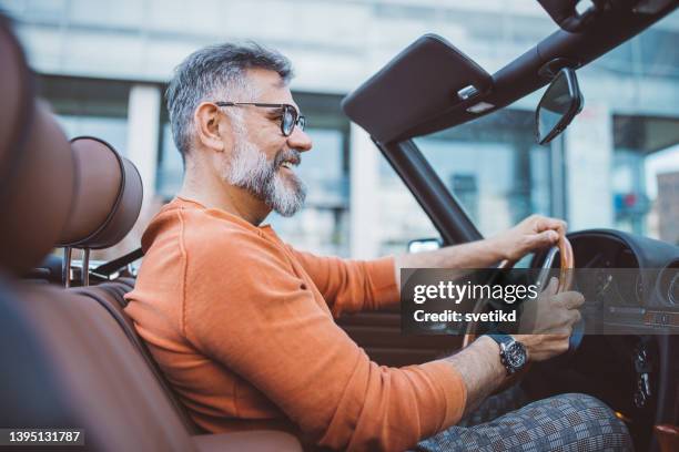 man driving vintage car through the city - driving audi stock pictures, royalty-free photos & images