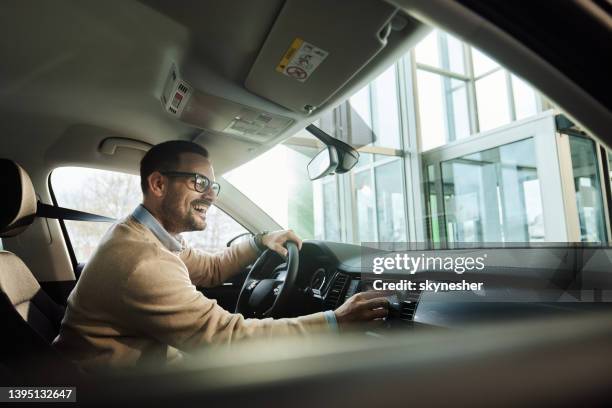 young happy man enjoying while traveling by car. - auto radio stock pictures, royalty-free photos & images