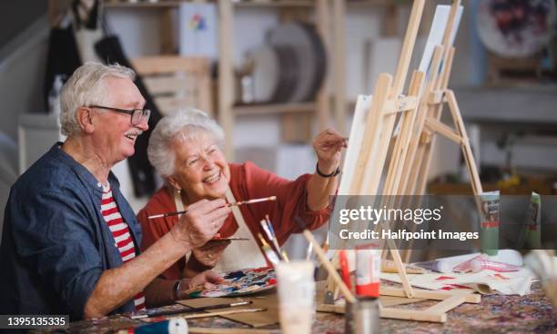 happy senior friends painting together at art class. - couple painting bildbanksfoton och bilder