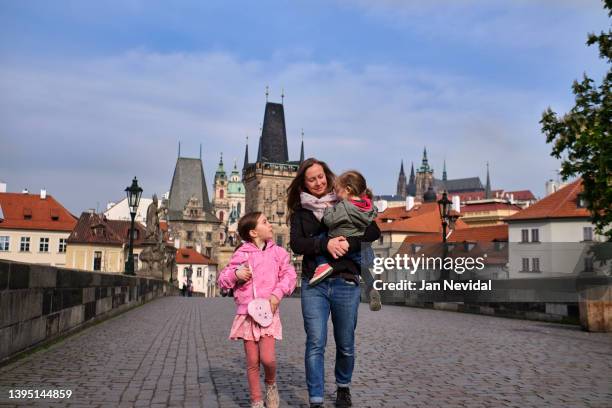 prague vacation experience - morning walk over charles bridge - prague people stock pictures, royalty-free photos & images