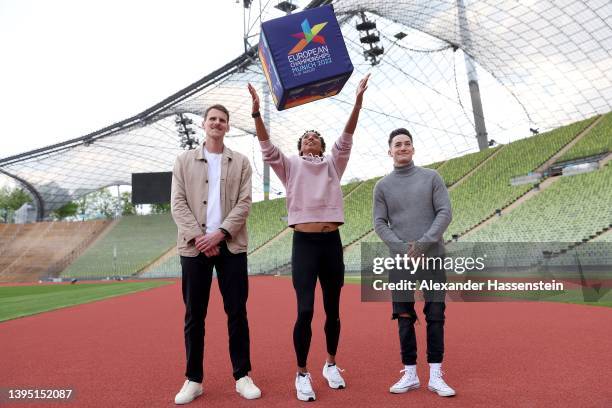 Olympic long jump champion Malaika Mihambo poses with para athlete Marc Lembeck and gymnast Marcel Nguyen the Olympiastadion prior to a press...