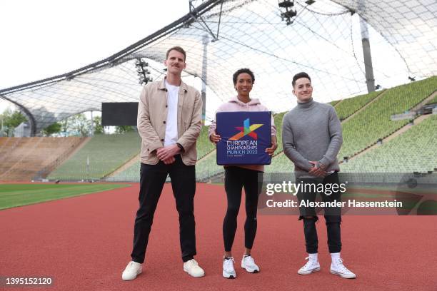 Olympic long jump champion Malaika Mihambo poses with para athlete Marc Lembeck and gymnast Marcel Nguyen the Olympiastadion track prior to a press...