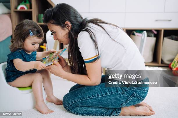 potty training. - girls peeing stock pictures, royalty-free photos & images