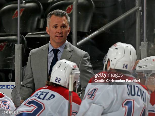 Interim head coach Martin St. Louis of the Montreal Canadiens looks on from the bench during the game against the New Jersey Devils at the Prudential...