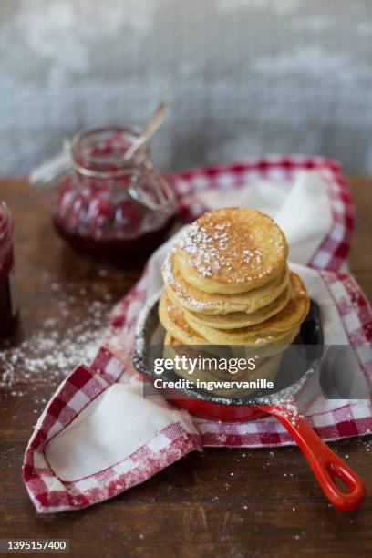 stack of pancakes on wooden table - american pancakes stock pictures, royalty-free photos & images