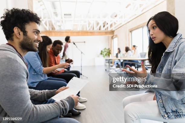 young man smiles at female friend practicing monologue - amateur theater stock pictures, royalty-free photos & images