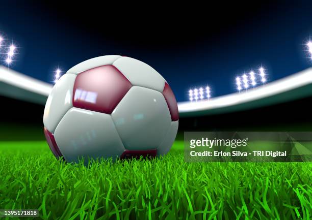soccer ball in the center of football stadium lawn with colors of qatar world cup host - international soccer event stock pictures, royalty-free photos & images