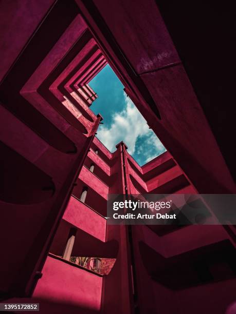 red architecture with different levels and stunning design seen from below.. - patio de edificio fotografías e imágenes de stock