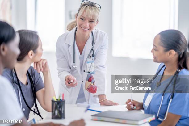 professor teaching medical students - female-heart-exam stock pictures, royalty-free photos & images