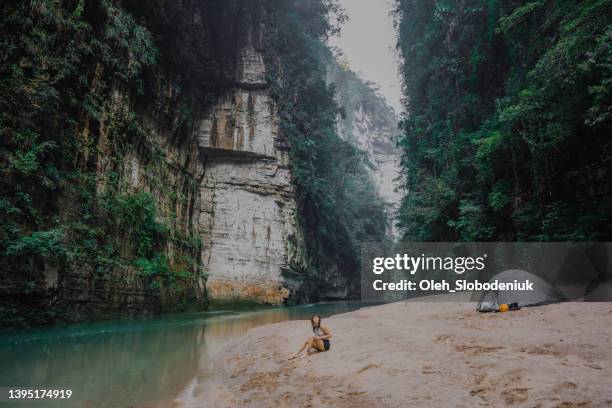 woman sitting near  the turquoise river in  mexico - chiapas stock pictures, royalty-free photos & images