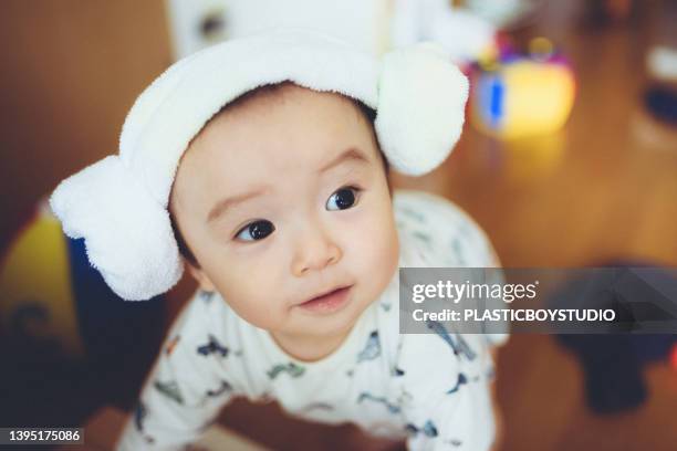 a baby wrapped in a towel. - 日本人　赤ちゃん ストックフォトと画像