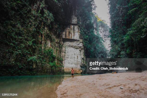 man walking near the turquoise river in  mexico - chiapas stock pictures, royalty-free photos & images