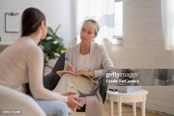 distraught woman in therapy - therapist imagens e fotografias de stock