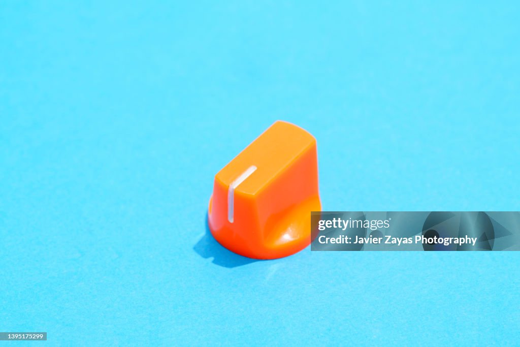Orange Plastic Knob On Blue Background