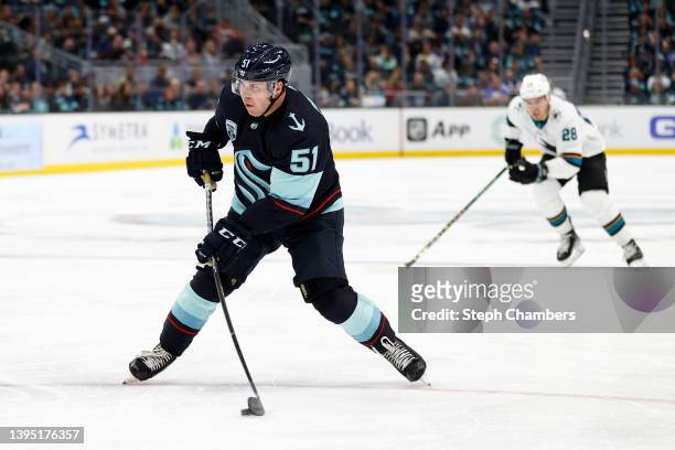 Derrick Pouliot of the Seattle Kraken skates with the puck against the San Jose Sharks during the second period at Climate Pledge Arena on April 29,...
