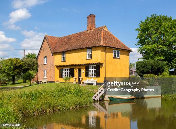 Historic farmhouse building by pond, Hill Farm, Whatfield, Suffolk, England, UK.