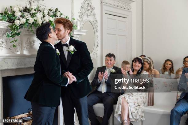 kiss the groom - wedding ceremony kiss stock pictures, royalty-free photos & images