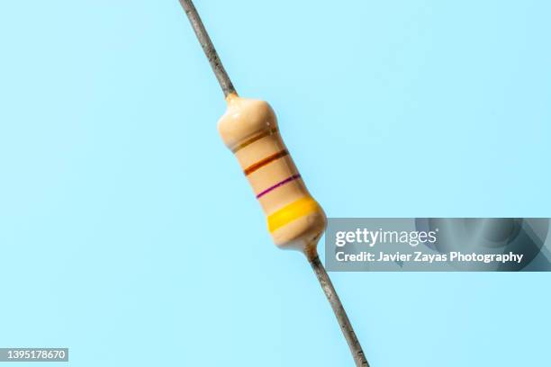 carbon resistor on blue background - resistor stock pictures, royalty-free photos & images
