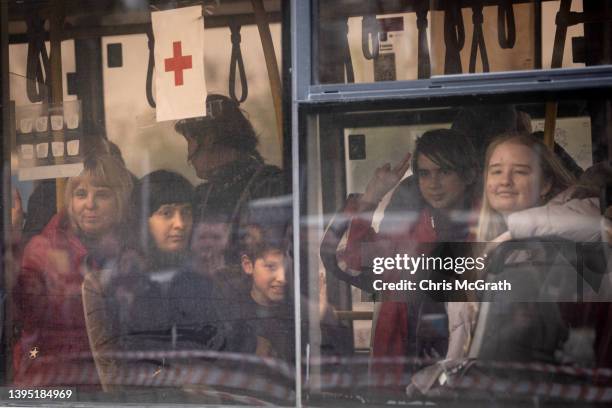 Evacuees including some from the Azovstal plant wave as they arrive on a bus at an evacuation point for people fleeing the Azovstal plant, Mariupol,...