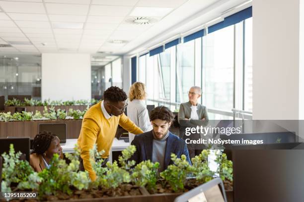 black male team leader directing his team - directing stock pictures, royalty-free photos & images