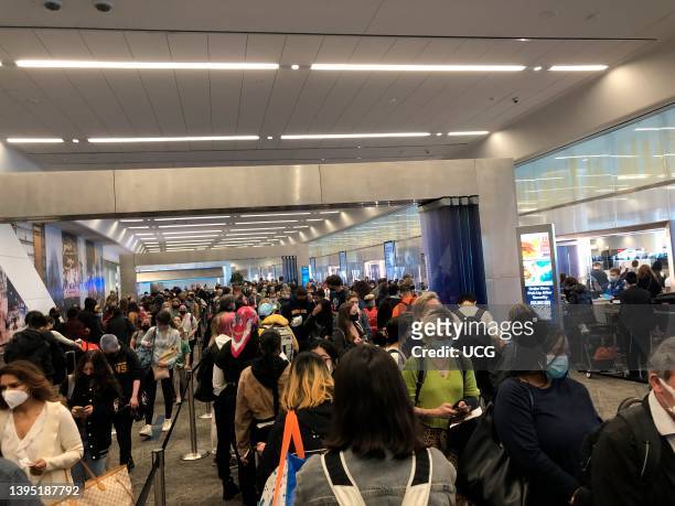 Large holiday crowds waiting in long line to enter TSA security at newly renovated LaGuardia Airport, Queens, New York.