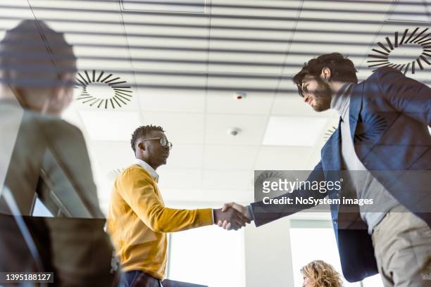 businesspeople handshake after contract signing - shareholder's meeting stock pictures, royalty-free photos & images