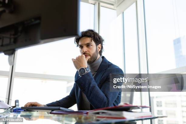 handsome ceo working in his modern luxury office. - bank manager imagens e fotografias de stock