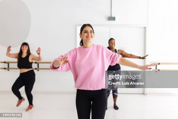 woman doing zumba dance at fitness class - woman dance studio stock pictures, royalty-free photos & images