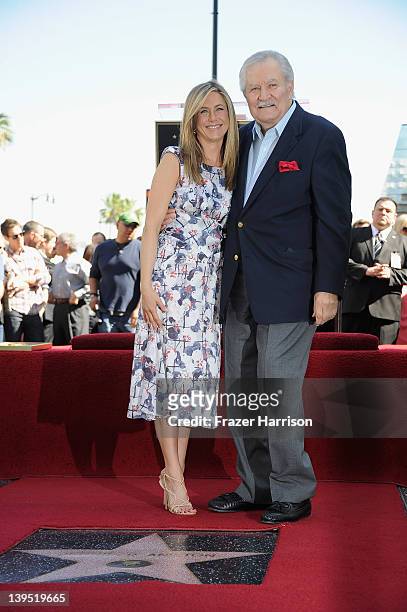 Actress Jennifer Aniston poses who was honored with a star the the Hollywood Walk Of Fame poses with her father John Aniston on February 22, 2012 in...