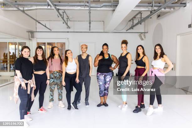 portrait of diverse group of people standing at fitness dance studio. - german indian society stock pictures, royalty-free photos & images