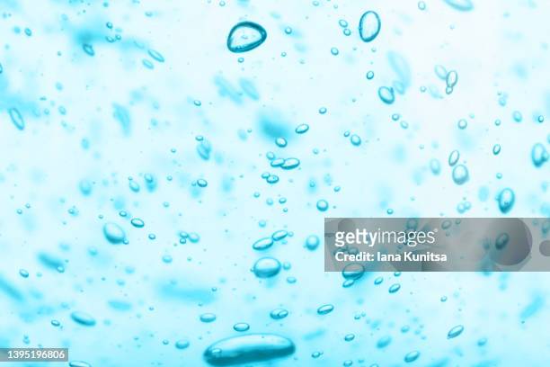 water with bubbles. transparent blue moisture serum for face. hydrating hyaluronic acid. cosmetic products for makeup and skin care. - humidity stock pictures, royalty-free photos & images