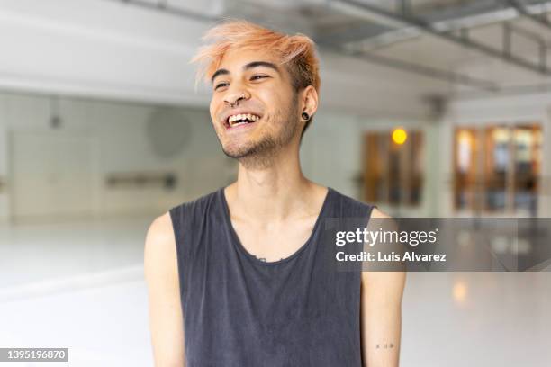 cheerful young asian man in a dance studio - young sporty man stockfoto's en -beelden