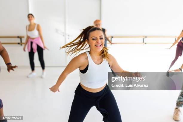 group of people dancing in fitness studio - dance instructor stock-fotos und bilder