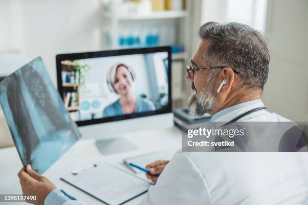 doctor meeting remotely with his patient - scientific imaging technique stock pictures, royalty-free photos & images