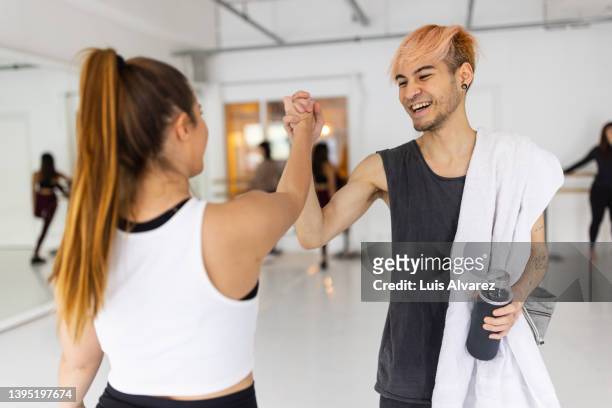 young man giving high-five to dance teacher at class - hi five gym foto e immagini stock