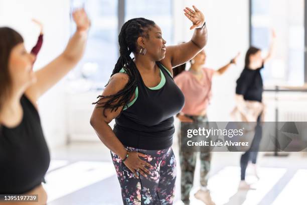 group of women doing dance workout at health club - fat woman dancing stock pictures, royalty-free photos & images
